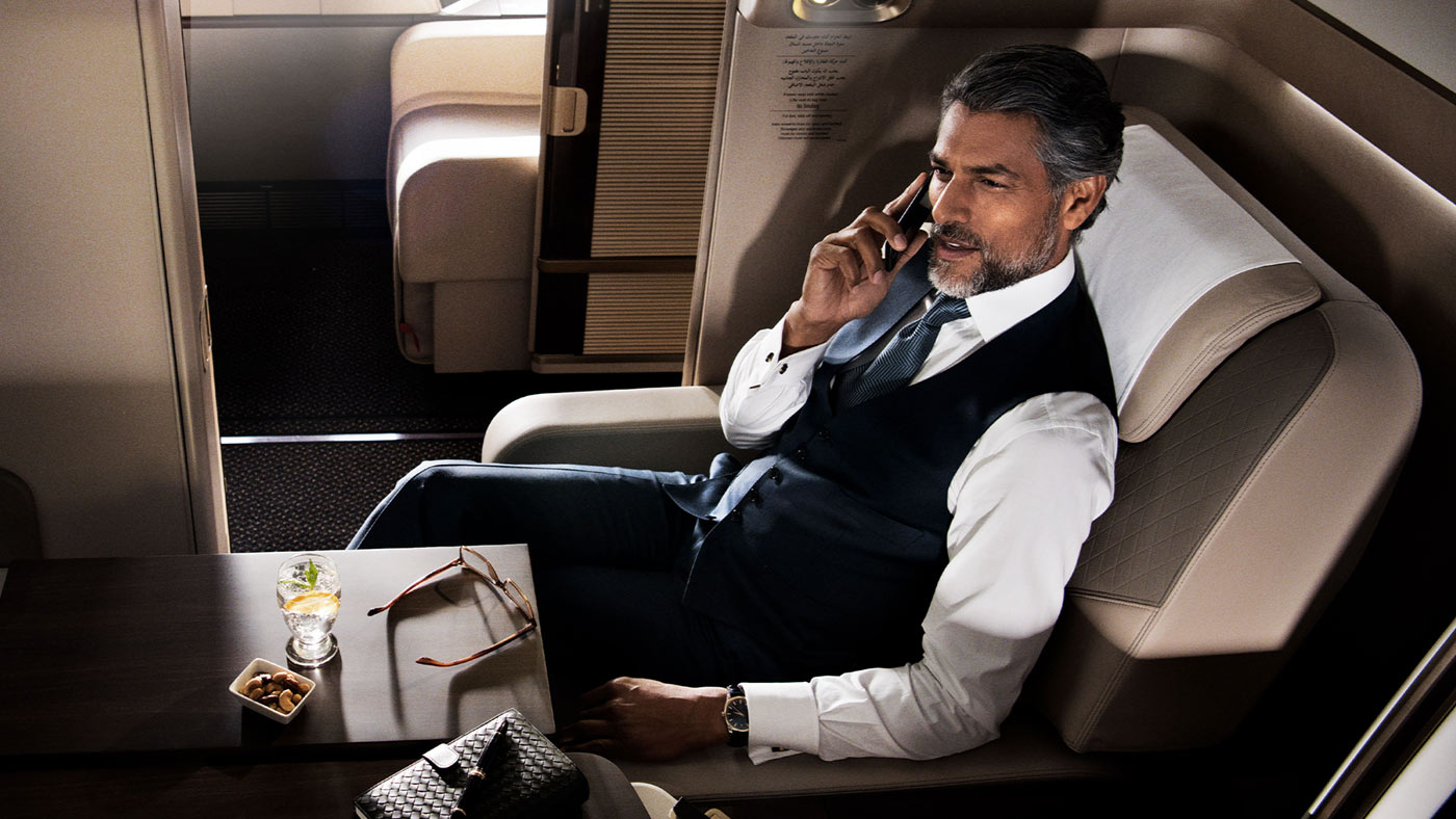 Male passenger in first class talking on the phone