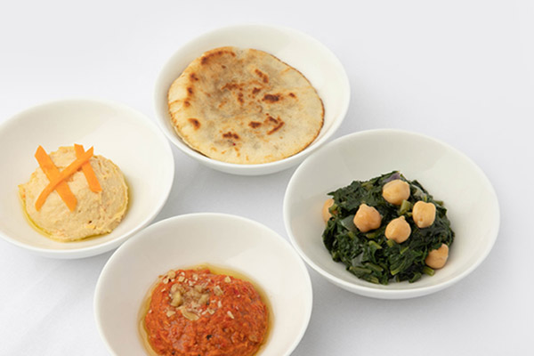 Arabic spiced chickpea soup - Root vegetables and dates baby spinach chickpea garnish, warm lamb arayees